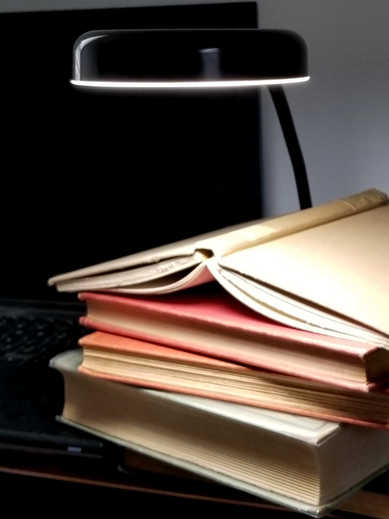 Old books, desk lamp and computer.jpg