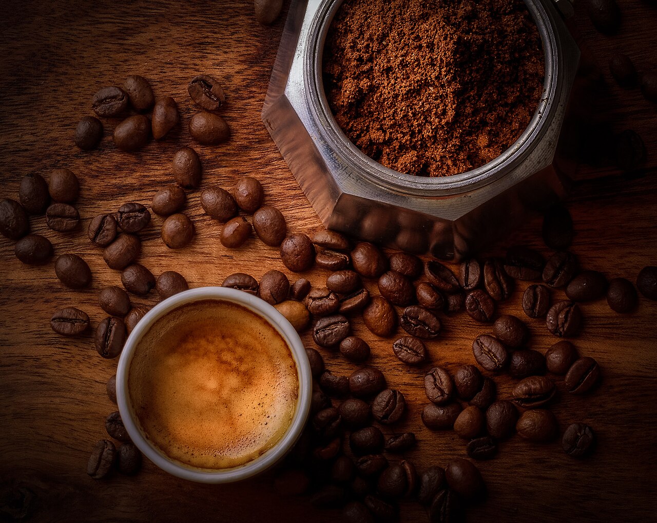 White Ceramic Mug Filled With Coffee Beside Coffee Beans (43087322071).jpg